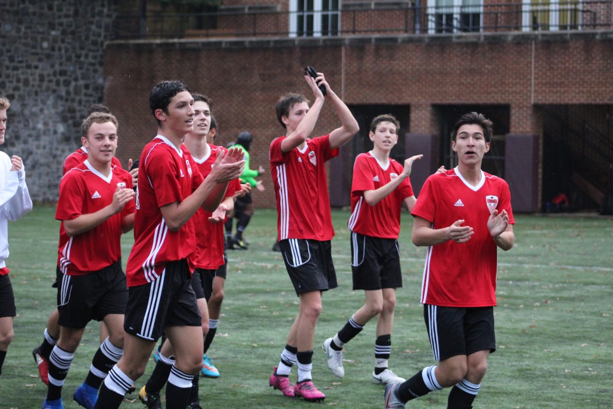 Boys Varsity Soccer players celebrate after last years DCSAA quarter final victory over St. Albans. The team is aiming for more PVAC and DCSAA dominance this season, under the leadership of an experienced coach. (Bella Valla/Photo)