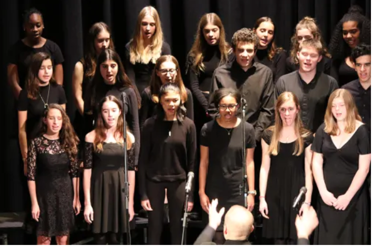 Upper school vocal students singing at a school concert in the Black Box Theater a few years ago. It is uncertain when the next in-person concert will be. (WIS website)