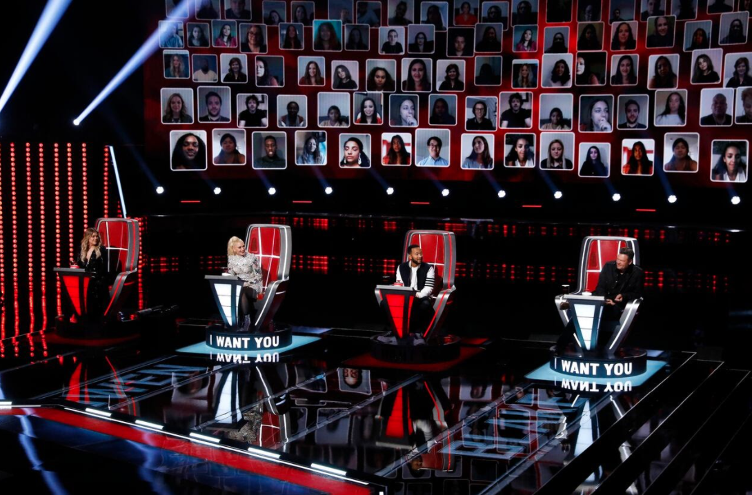 Coaches Kelly Clarkson, Gwen Stefani, John Legend and Blake Shelton sit in their chairs as the virtual audience watches from behind. (Trae Patton/NBC)