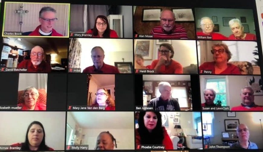 Rector Charles Brock leads congregant Mary Bramley and the rest of St. James’ Episcopal Church’s congregation in prayer over Zoom. They are wearing red to celebrate St. James, the church’s namesake. (Courtesy of Charles Brock)