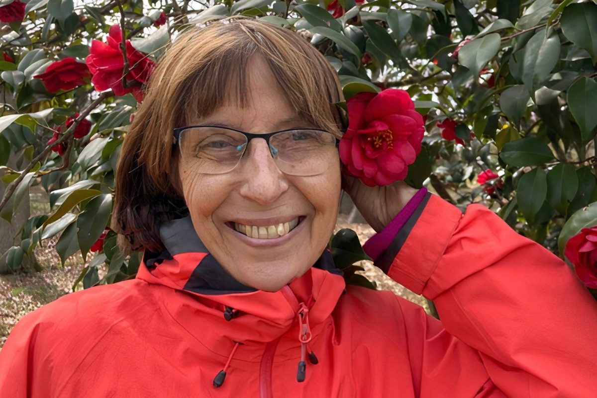 Ana Andura smiling and holding a flower in her hair. Andura, who taught IB Spanish at WIS for 23 years, passed away in May 2021. (Courtesy of @anaandura)