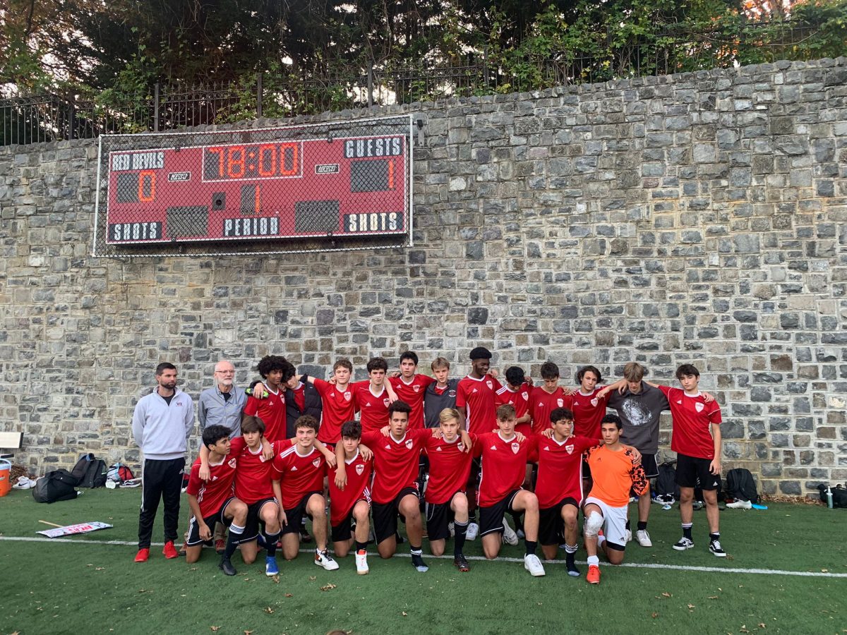 Soccer coach James Martin with the boys varsity soccer team of the 2021 season. Martin has been coaching the team since 2009, and will finally retire this year. (Mila Martin/International Dateline)