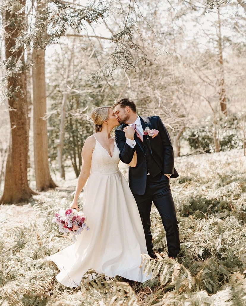 Audette (left) and Sopher (right) kiss in the Tregaron Conservancy on their wedding day, April 2, 2022. (Courtesy of Paperbird Photography) 