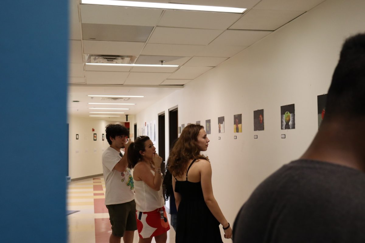 Parents and students observing students’ art at the Grades 8-11 art show. (Andrea Brudniak-Berrocal/International Dateline)
