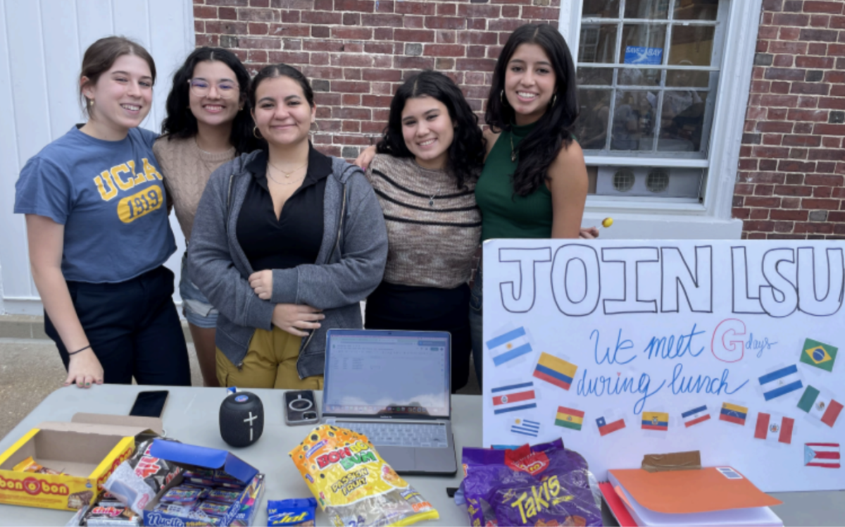 The Latine Student Union (LSU) leaders pose at the Upper School Club Fair.
From left to right: seniors Isabel Restrepo, Ariana Campo, Natalia Martina,
Kathy Lee and Luana Dos Santos. (Courtesy of Luana Dos Santos)
