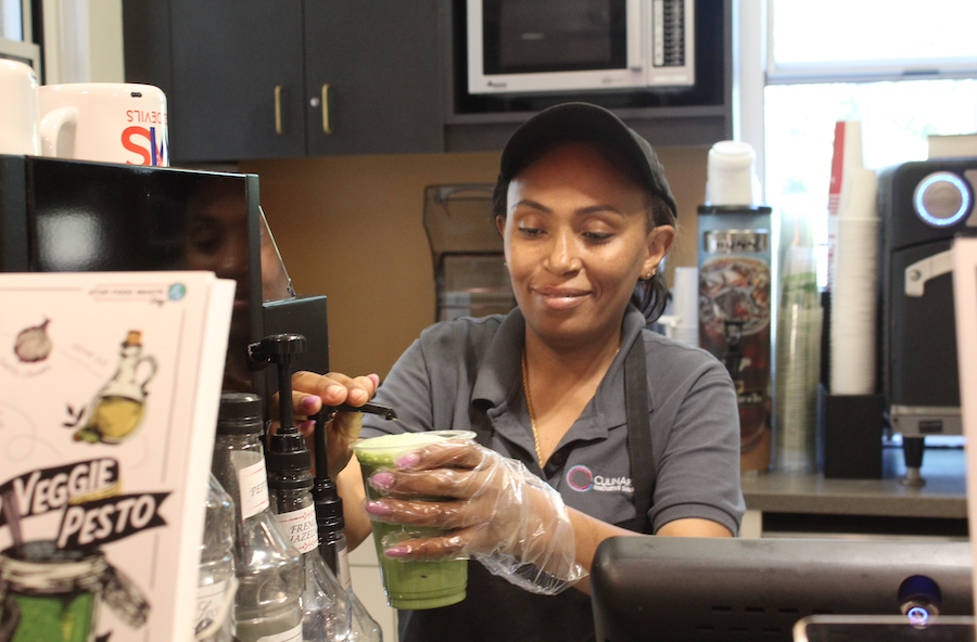 Freh Tesfaye making an iced matcha
in the IB cafe. Over the years, the cafe
has acquired a wider variety of food and
drink options, including her favorites:
muffins. (Martina Tognato Guáqueta/International Dateline)