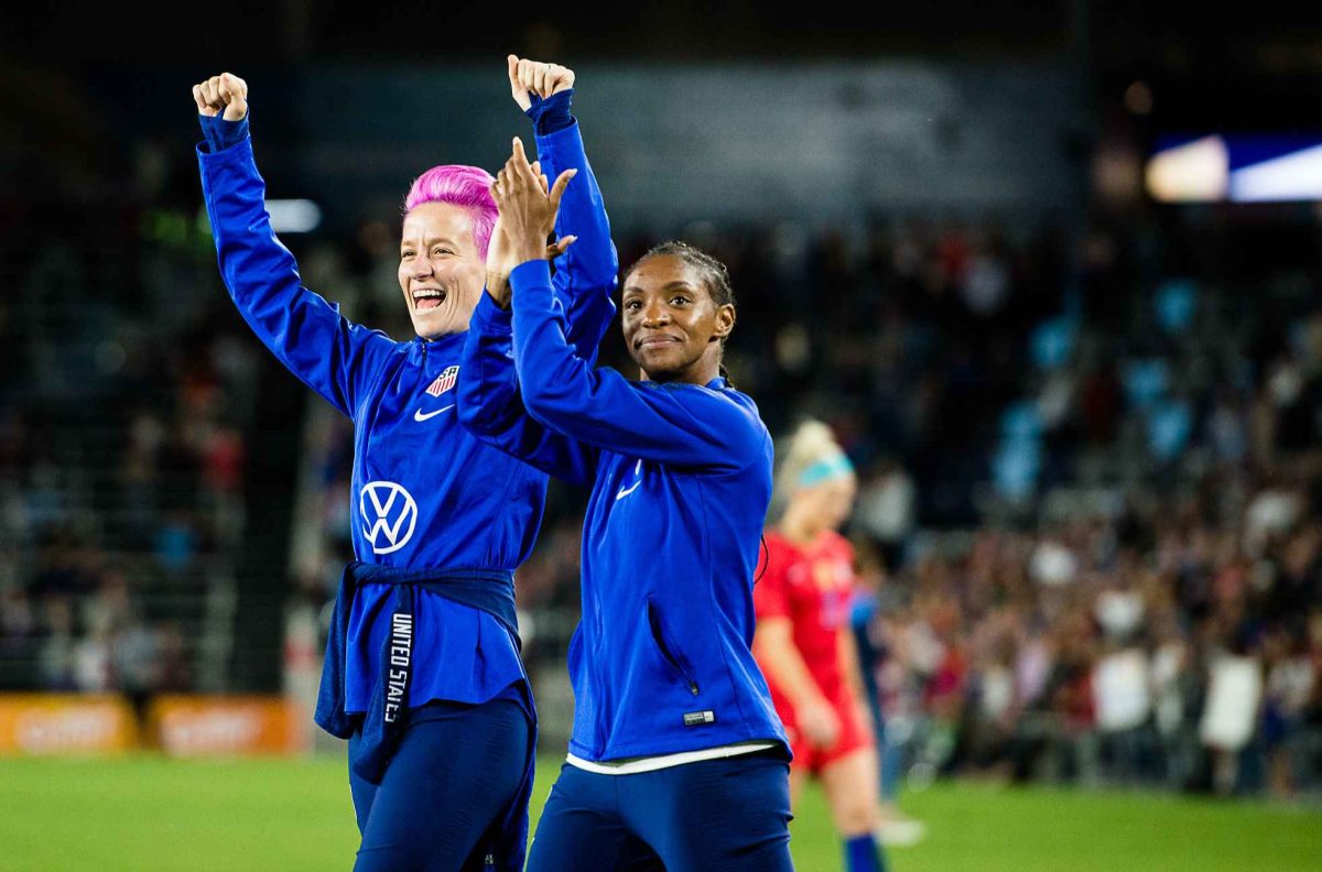 From left to right: Megan Rapinoe and Crystal Dunn celebrating with fans after win against Portugal in 2019. (Lordofthisworld/Flickr)