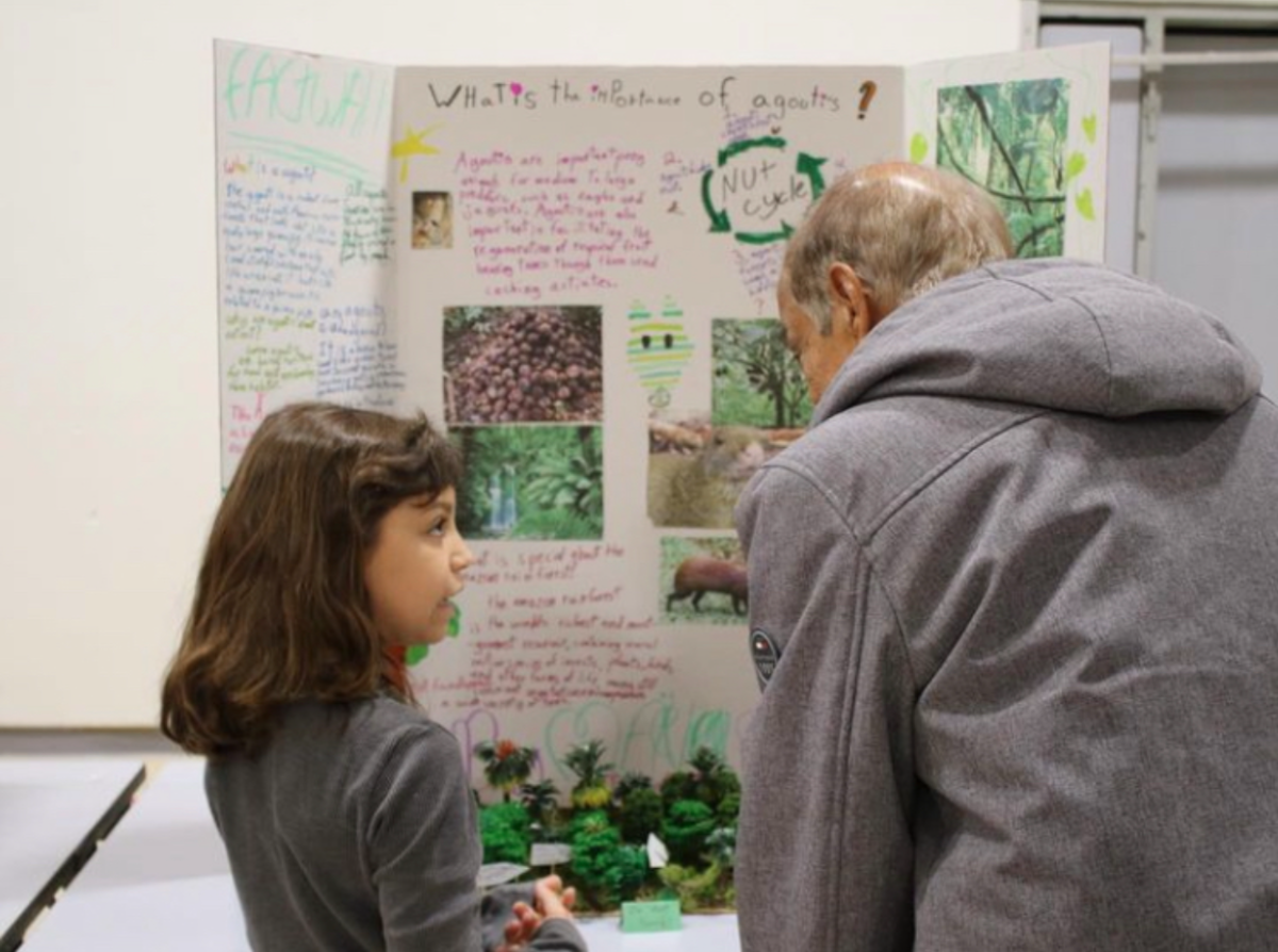 Third-grader Livia Benelli presenting her project on the Agoutis at this years STEAMFest. (Courtesy of @wisreddevils)