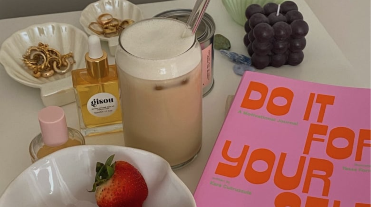 Some strawberries, a wellness shake, some perfume and a journal, all characteristics of the “That” girl aesthetic. While this trend may on the surface seem to promote health and wellness, in reality, it promotes the idea that there is only one right way to go about life. (Jessica Singer/CBC)
