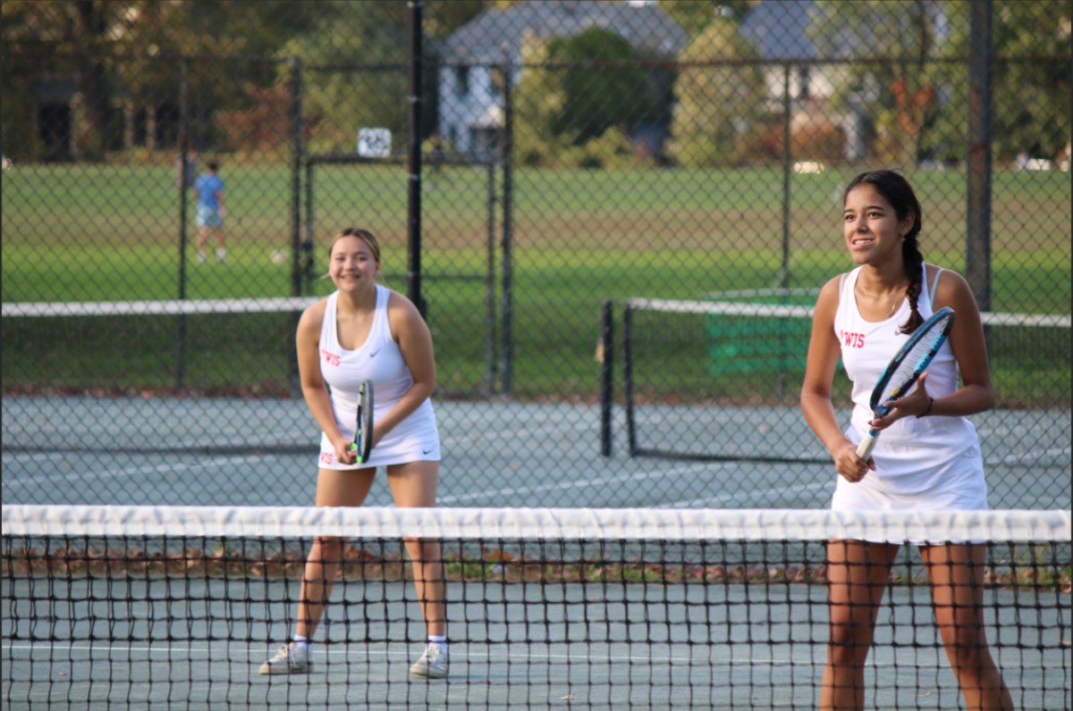 From+left+to+right%3A+seniors+Ava+Gonzalez+and+Lila+Lefevre-Iwata+playing+doubles+at+PVAC+finals+on+October+26th+2023.+The+tennis+team+made+it+up+to+PVAC+finals+ultimately+losing+to+Charles+E.+Smith+Jewish+Day+School+%28JDS%29.+%28Courtesy+of+Cheryl+Tanski%29+