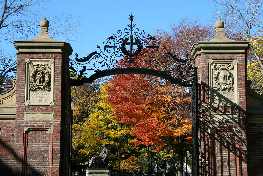 The gates to Harvard with fall foliage behind them. Courtesy of Tim Sackton on Flickr.