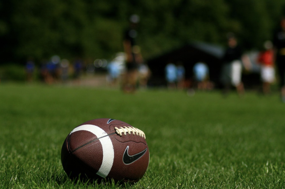 An American football on an open field. The sport is not offered at WIS despite its popularity around the rest of the country. (Eierschneider/Flickr)