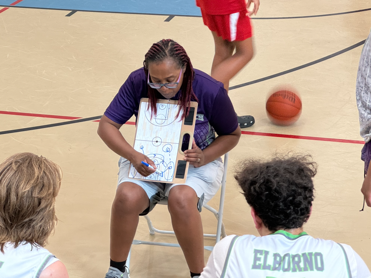 Coach Tori Moten strategizes during a game, demonstrating her leadership and commitment to her basketball team’s success (Courtesy of Tori Moten).