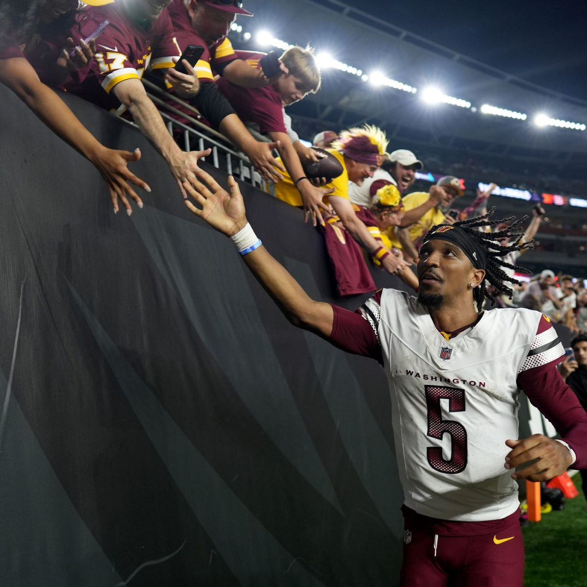 Jayden Daniels high-fiving fans after a game. (Horgan/Hogs Haven)